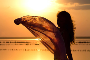 silhouette of a young girl with a shawl