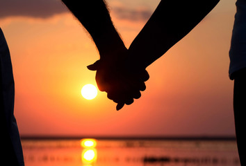 couple at sunset holding hands