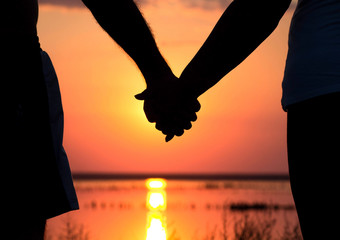 couple at sunset holding hands