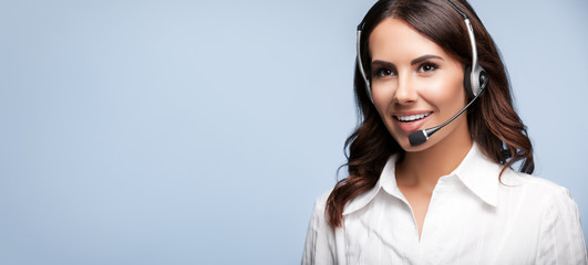 smiling customer support female phone operator in headset