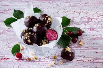 Delicious homemade candy, cake with cherry and cream cheese on a wooden table