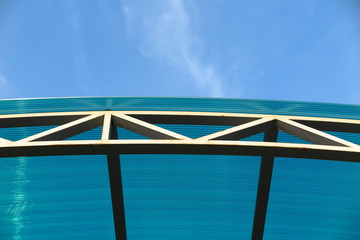 Arc polycarbonate canopy against a blue sky