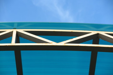 Fototapeta na wymiar Arc polycarbonate canopy against a blue sky
