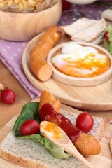 Fototapeta na wymiar Breakfast with eggs, sausage, bread, salad vegetables and milk.