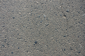 The smooth texture of the gray asphalt