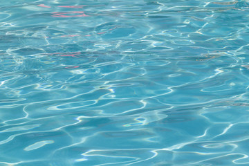 Fototapeta premium Blue pool water with sun reflections