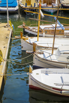 Fototapeta Fishing small white boats tied on a pier
