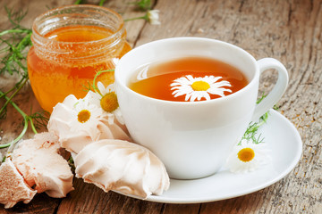 Black tea with chamomile, honey and marshmallow, selective focus