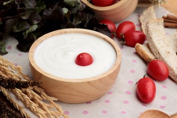 White yogurt and fresh cherry tomatoes