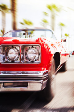 Fototapeta Red classic sports car driving fast. Motion Blur.