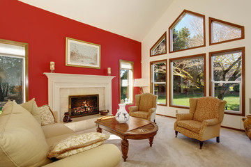 Modern living room with bright red wall and nice decor.