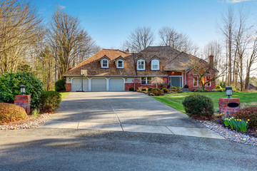 American traditional home with large driveway.