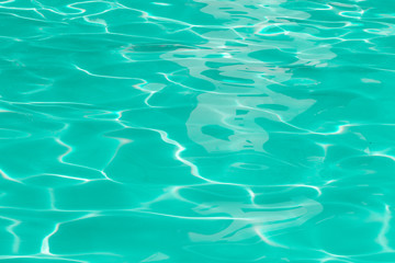 green pool water with sun reflections