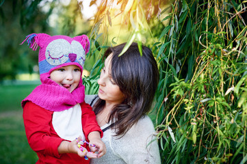 Mom holds daughter on hands