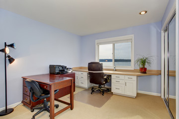 Perfect office with carpet, and periwinkle walls.