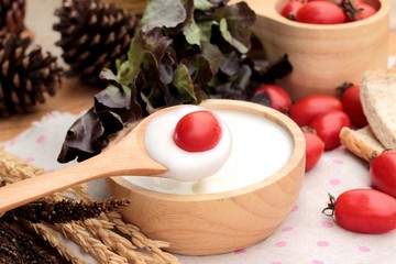 White yogurt and fresh cherry tomatoes