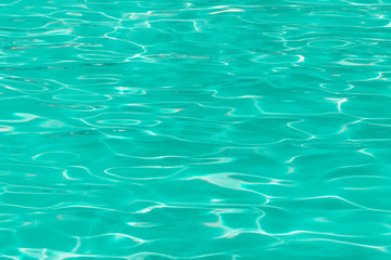 green pool water with sun reflections