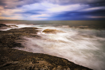 Sunset on a rocky shore.
