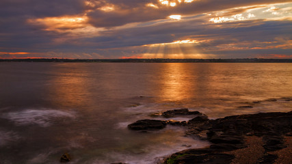 Sunset on a rocky shore.