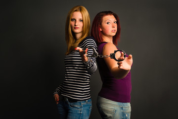 two young women with handcuffs