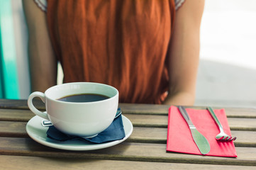 Young woman drinking coffee outside