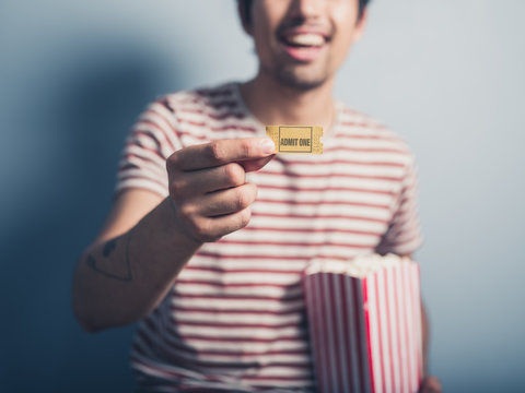 Man with cinema ticket and popcorn