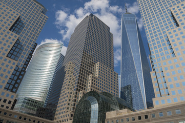 Fototapeta na wymiar Downtown Manhattan skyline featuring modern shiny skyscrapers under bright blue sky