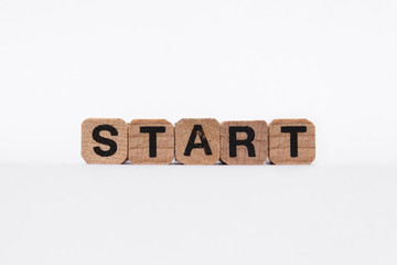 Start - text on wooden cubes, isolated on white background