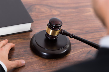 Judge Hitting Mallet At Desk