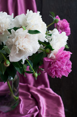 white and pink peonies on rustic wooden background