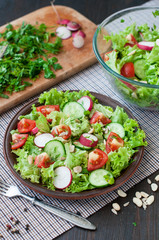 Tomato and cucumber salad with lettuce leafes
