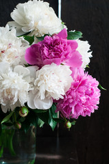 white and pink peonies on wooden background