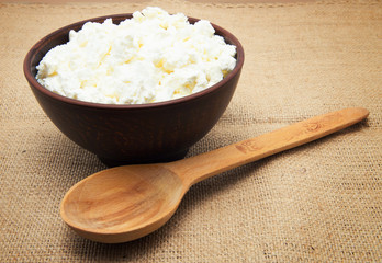curd in brown bowl on sacking