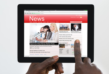 Person Watching News On Digital Tablet