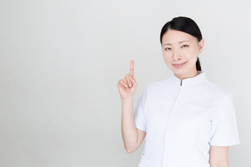 young asian nurse on white background