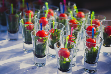 Beautifully decorated catering banquet table with different food snacks and appetizers with sandwich, caviar, fresh fruits on corporate birthday party event or wedding celebration 