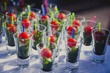 Beautifully decorated catering banquet table with different food snacks and appetizers with sandwich, caviar, fresh fruits on corporate birthday party event or wedding celebration 