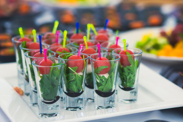 Beautifully decorated catering banquet table with different food snacks and appetizers with sandwich, caviar, fresh fruits on corporate birthday party event or wedding celebration 