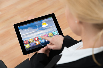 Fototapeta na wymiar Businesswoman Using Digital Tablet With App