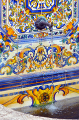 Colourful Spanish tiles decoration on water faountain