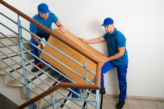 Two Movers With Box On Staircase