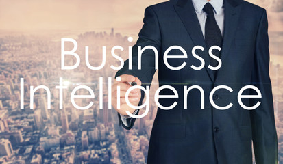 Businessman sketching and writing Business Intelligence with nice business city background in retro colors.