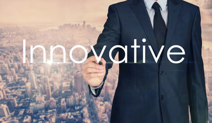 Businessman sketching and writing Innovative with nice business city background in retro colors.