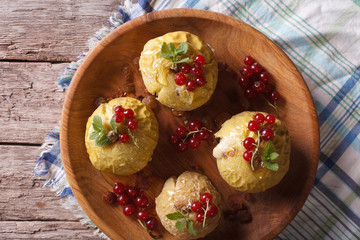 Rustic baked apples with honey and currant closeup. horizontal top view
