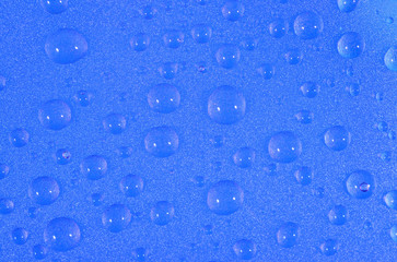 Water drops on the blue surface
