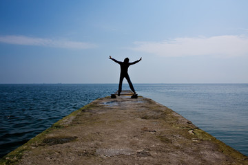 black silhouette of man in happy jump