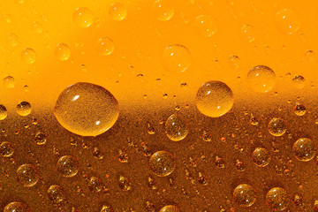 Water drops on the brown surface. Selective focus.