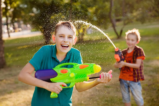 boys having fun playing with water guns