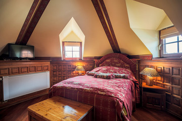 Stylish bed in antique bedroom