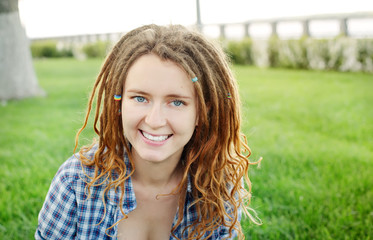 Young stylish girl with dreadlocks outdoors